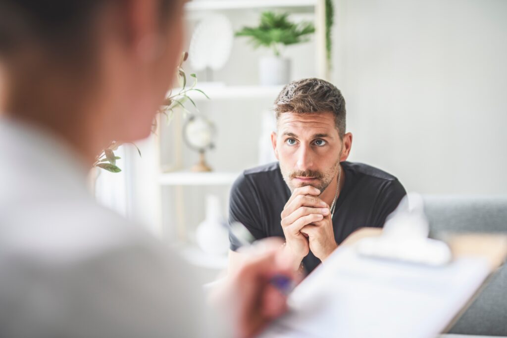 A man listening while his provider explains What To Expect In Residential Mental Health Treatment.